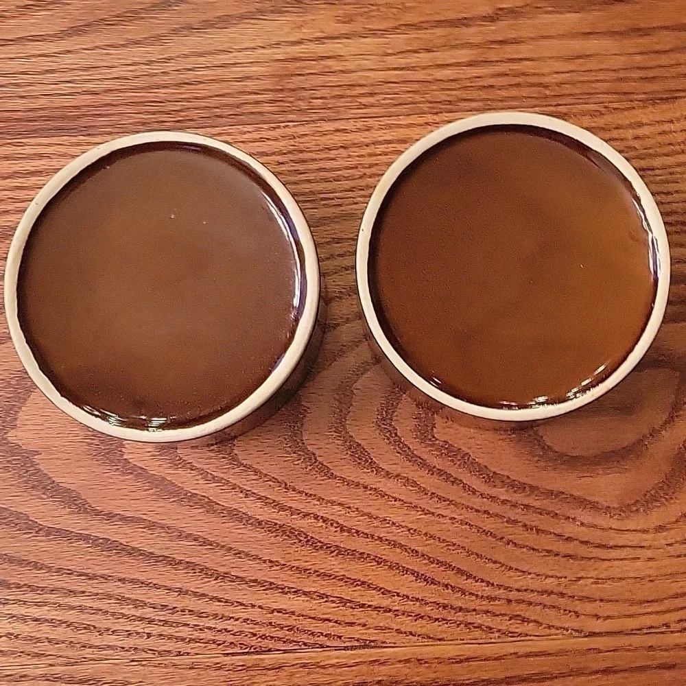 Two dark brown ceramic stoneware dog bowls.  5